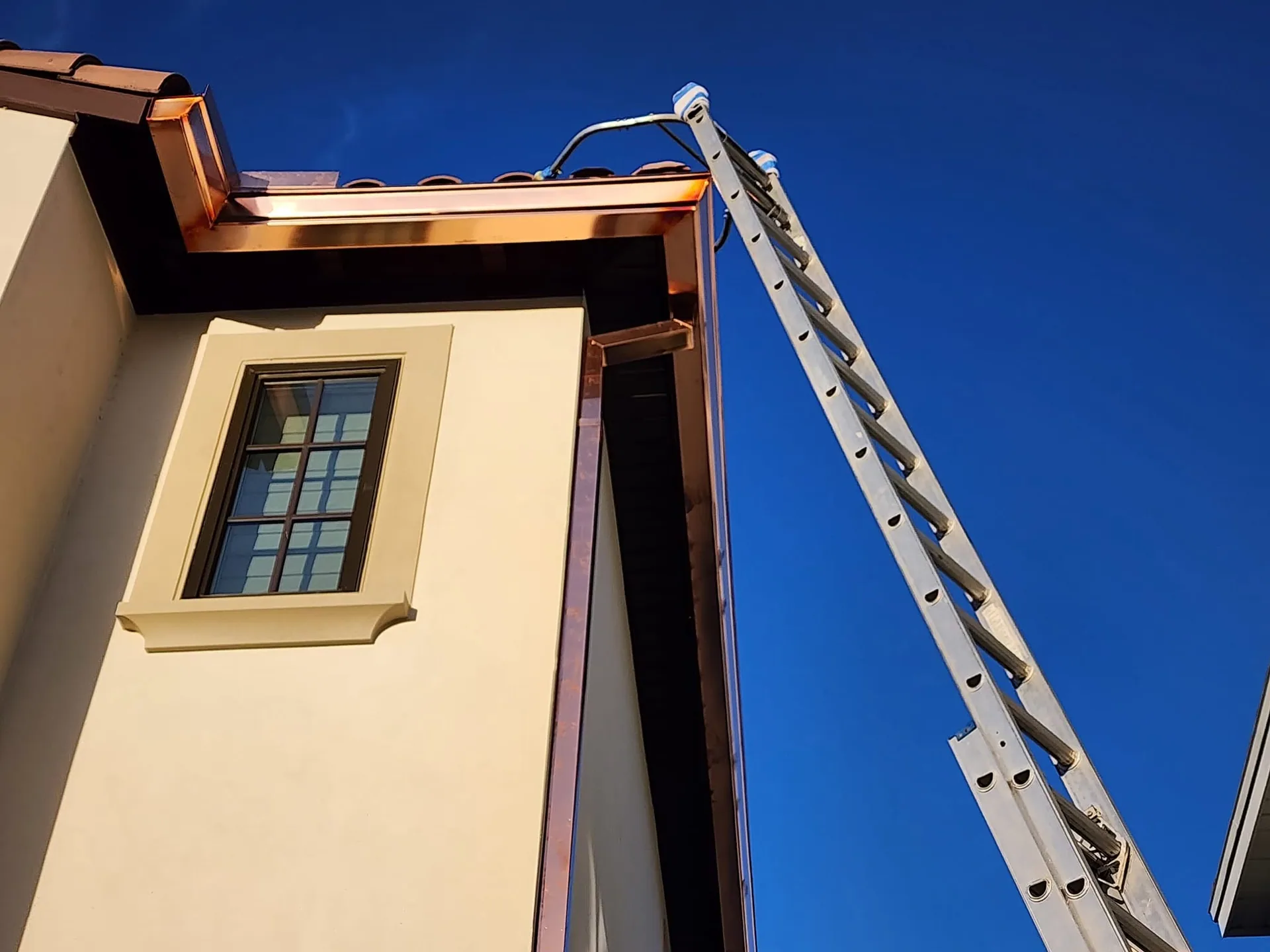 Low angle copper k style gutter install extension ladder cream stucco, Sanford